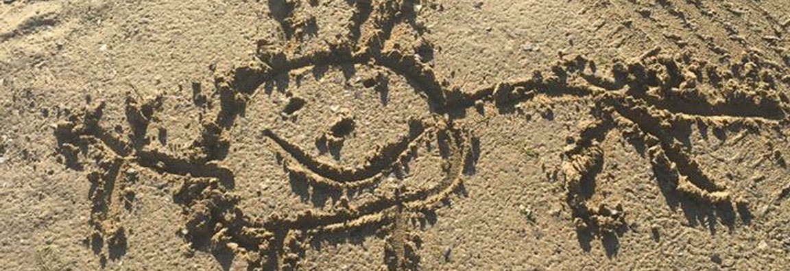 Sun drawn in the sand